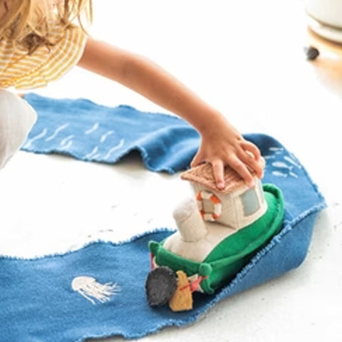 Juguete textil RIDE & ROLL Barco con camino enrollable